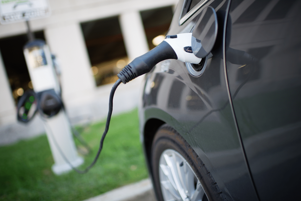 Electric vehicle plugged in at a charging station.